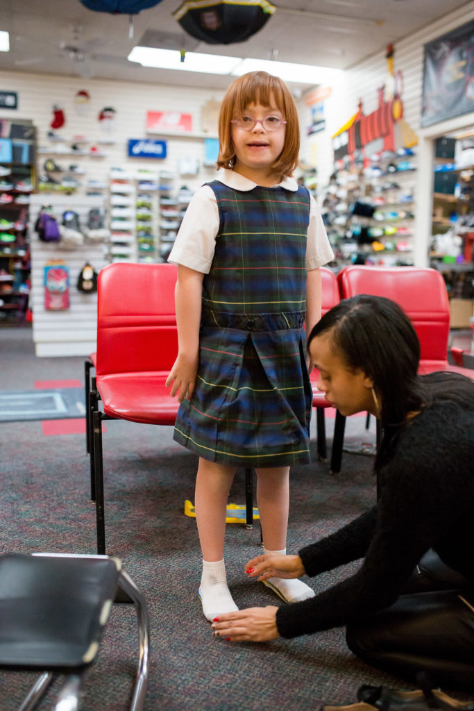 Girl being fitted for shoes