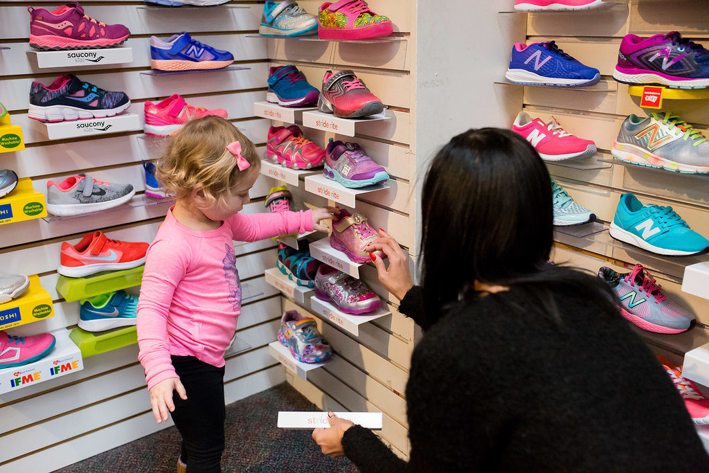 Little girl picking out shoes